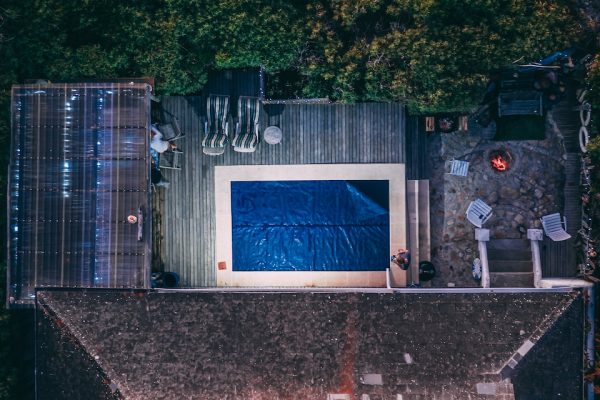 aerial view of house with outdoor pool and garden